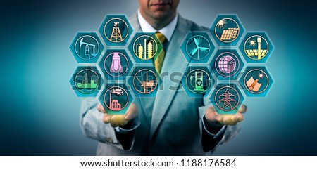 Manager balancing out fossil fuels and renewable energy resources in the palm of his hands. Metaphor for energy industry sectors, electric power generation via sustainable sources, energy transition. Royalty-Free Stock Photo #1188176584