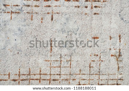 Texture of aged concrete plate with wire fittings. Grunge backdrop of old wall with rusty reinforcement.