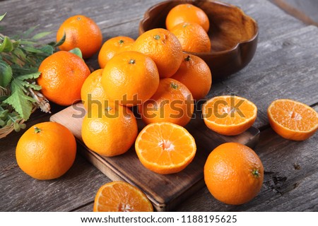 Tangerine fruits on wood background Royalty-Free Stock Photo #1188195625