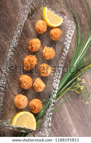 Fried fish cakes on glass plate
