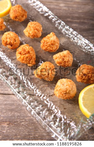 Fried fish cakes on glass plate