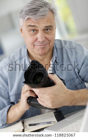 Photographer holding professional camera
