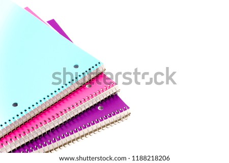 Top view studio shot three 1-subject notebooks isolated on white background. Colorful assortment classroom classic college-ruled notebooks with 3-hole punched to fit standard binder, back to school