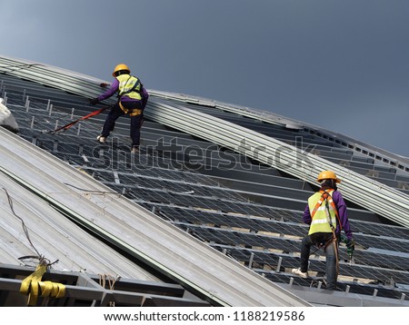 construction worker wearing ful safety to roofing metal sheet factory Royalty-Free Stock Photo #1188219586