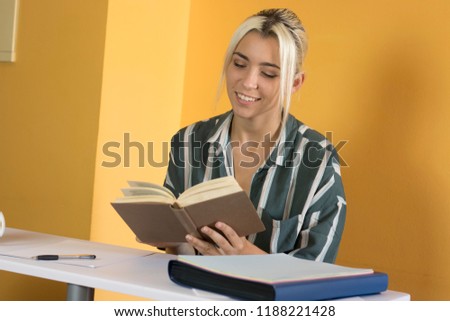 Woman reading a book in the office