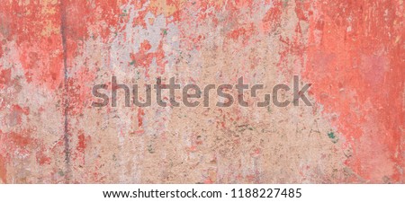 Old weathered painted wall background texture. Red dirty peeled plaster wall with falling off flakes of paint. Royalty-Free Stock Photo #1188227485