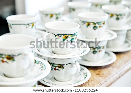 Mugs with a picture on a saucer