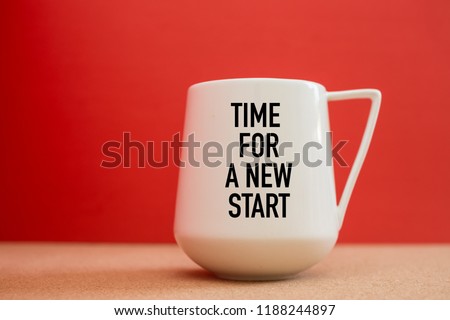 Time For a New Start on white cup against red background Royalty-Free Stock Photo #1188244897