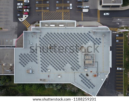 Aerial drone image of a rooftop solar power array.