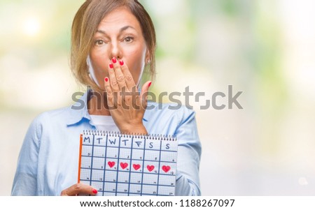 Middle age senior hispanic woman holding menstruation calendar over isolated background cover mouth with hand shocked with shame for mistake, expression of fear, scared in silence, secret concept