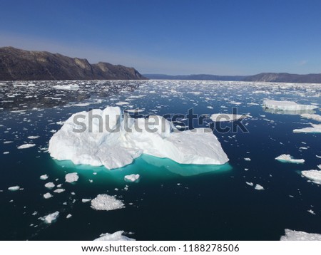 Oblique aerial drone image of many icebergs in a fjord in Greenland
