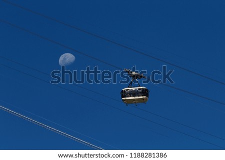 Sugarloaf mountain cable car full of tourists with crescent moon background (Rio de Janeiro, Brazil)