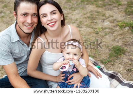 Happy young family having fun outdoors in summer garden Royalty-Free Stock Photo #1188289180