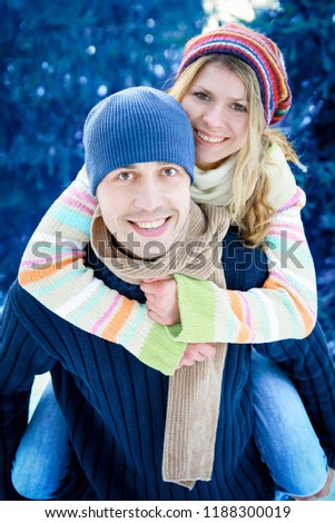young couple in love in the park in winter