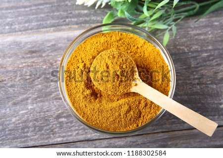 Curry powder in a glass bowl  Royalty-Free Stock Photo #1188302584