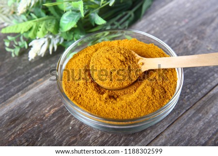 Curry powder in a glass bowl  Royalty-Free Stock Photo #1188302599