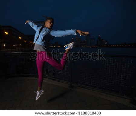 sporty women overlooking Canary Wharf, London