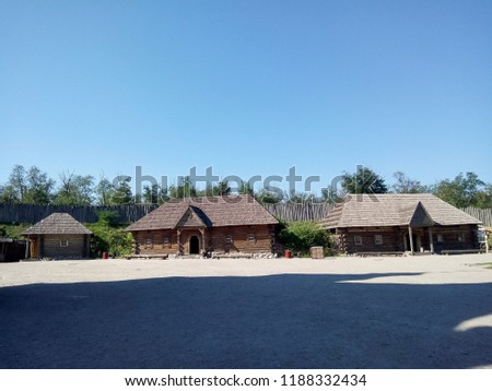 Wooden houses. Wooden buildings on Zaporozhye Sich in Ukraine. Roof made of reeds. Cossack House in Middle Ages