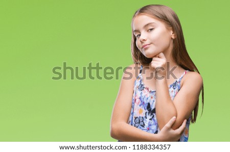Young beautiful girl wearing colorful dress over isolated background with hand on chin thinking about question, pensive expression. Smiling with thoughtful face. Doubt concept.