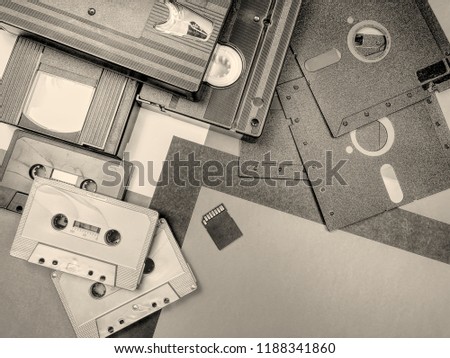 Tapes, floppy disk and memory card: old and modern technology. Sepia and hdr effect.