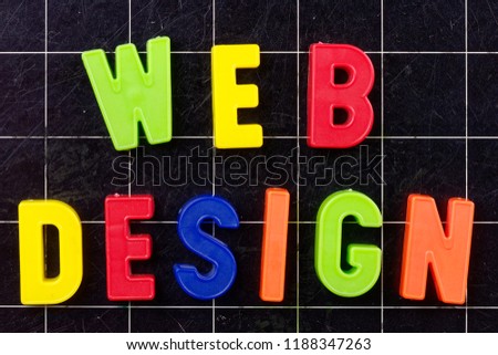 Web Design text with magnetic colorful letters on blackboard