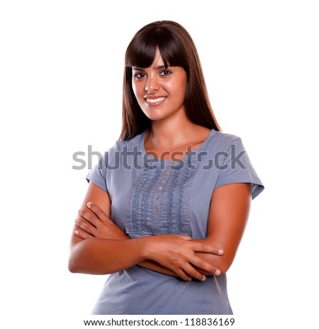 Attractive young woman on blue shirt looking at you on isolated background