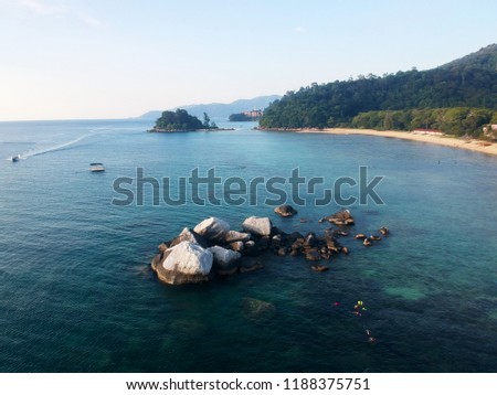 Aerial photo of the white rocks near Kampung Paya Beach in Tioman Island. The white boulder is a refuge for birds around the island. Picture taken using a drone.
