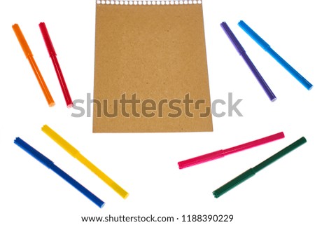 Colorful pens and straw paper
