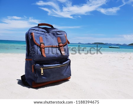Traveling bag on sea background.