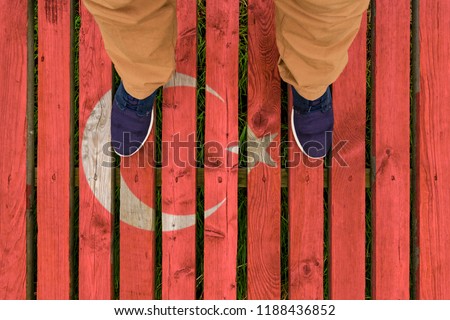 man stepped on a flag of Turkey painted on a wooden floor