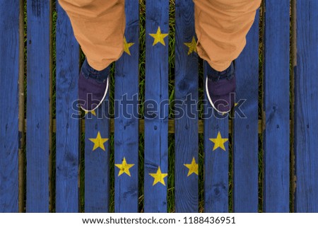 man stepped on a flag of EU painted on a wooden floor