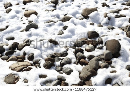 Snow on pebbles  