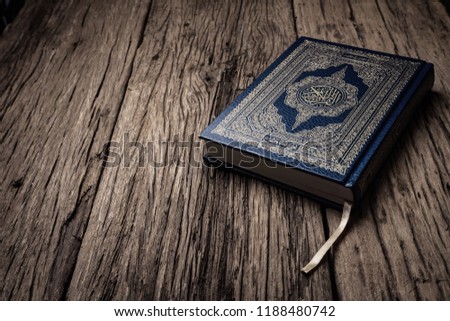 Koran - holy book of Muslims ( public item of all muslims ) on the table , still life  .