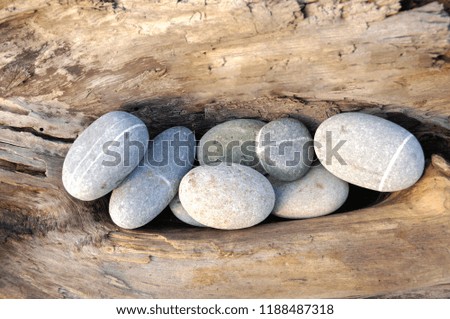 Pile of striped stones and old wood texture

