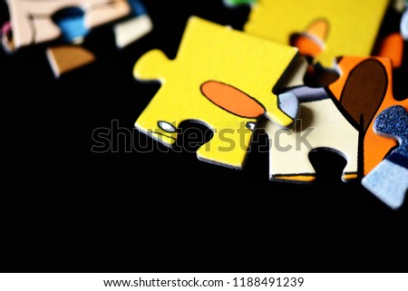 Children's puzzles scattered on a dark background close up