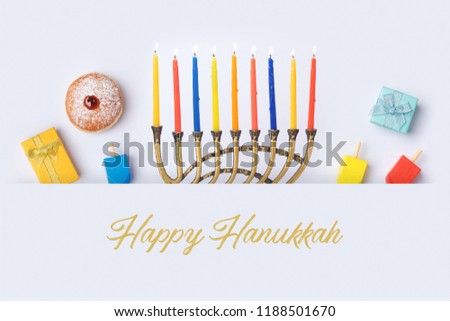 Jewish holiday Hanukkah banner design with menorah, sufganiyot and spinning top on white background. Top view from above. Flat lay