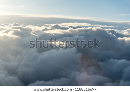 View of clouds from airplane window, a group of clouds in the sky