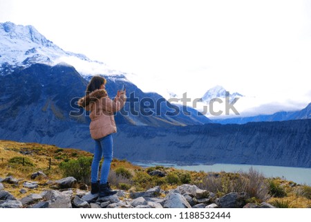 Tourist standing and taking photo front of Aroki mountain Mt.cook at view point