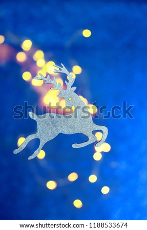 christmas toy reindeer on blue abstract background. new year and Christmas holiday. festive winter season concept. 