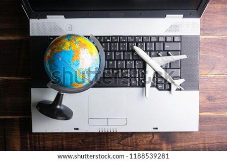 Passenger plane and Globe model on laptop notebook.Business travel transportation system concept.Online shopping concept