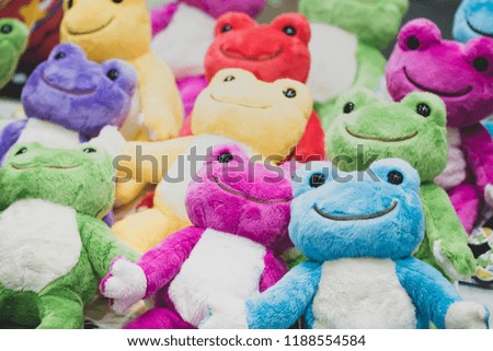 Multi-colored frog dolls.