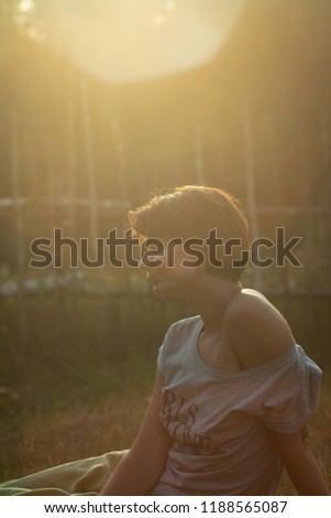 Beautiful Caucasian girl dreaming outside countryside nature background lens flare. Young woman looking up sky pensive green sunny forest copy space text. Thought idea solution concept