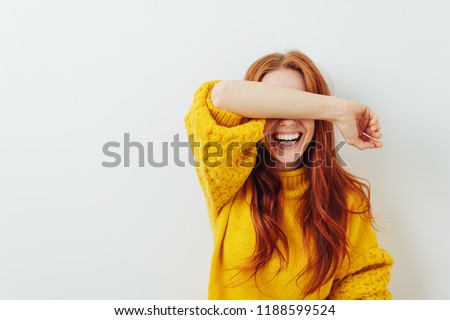 woman covering her eyes with her arm while waiting for a surprise Royalty-Free Stock Photo #1188599524