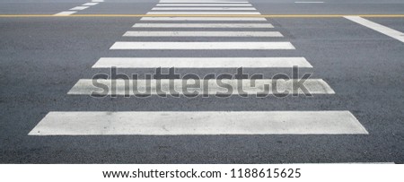crosswalk on the road for safety when people walking cross the street, Pedestrian crossing on a repaired asphalt road, Crosswalk on the street for safety, logistic import export and transport industry