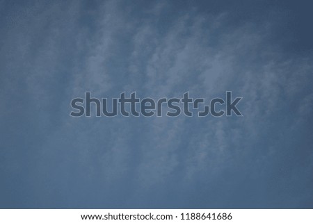 Not large clouds dissolve in the blue endless sky on the blue expanse as in the picture the wind drives away the huge capes of air creating an original background