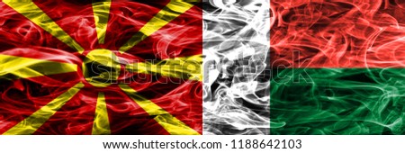 Macedonia vs Madagascar colorful concept smoke flags placed side by side