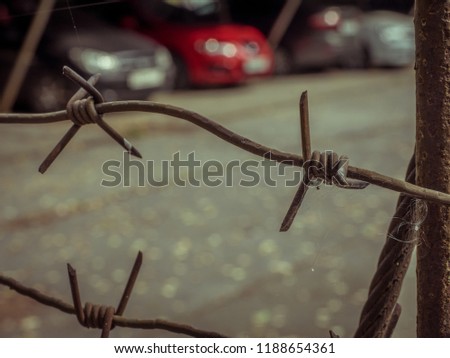 Close up barbed wire, parking fine, arrest of cars.