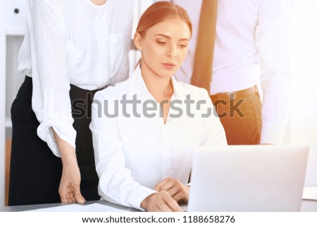Group of business people using laptop computer in office. Meeting and teamwork concept