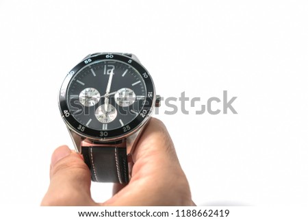 Men's wrist watches with black dial and dark gray stitched watch leather in the vintage style on hands with a white background. Selective focus. Horizontal image. 