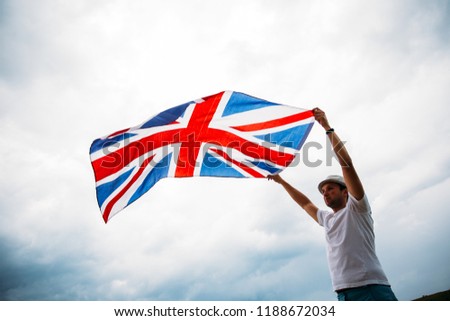 Man holding proudly the British flag. Patriot and supporter of Great Britain. 
